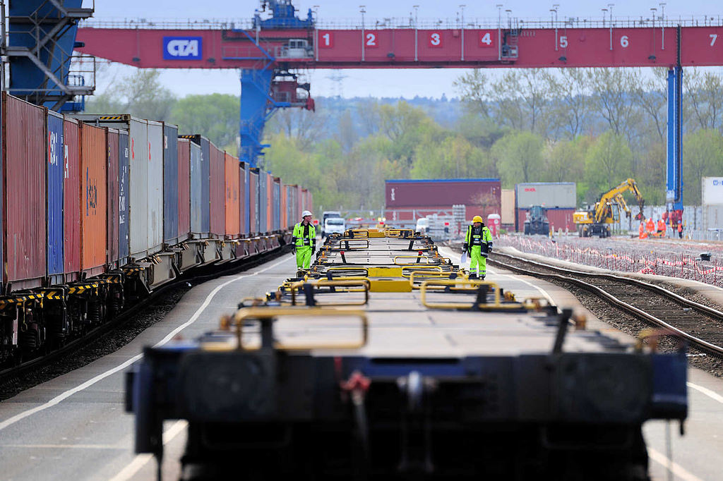 8476 Die Ladung eines Containerzugs wird im Containerbahnhof Hamburg Altenwerder gelöscht - einer der Container wird mit einem Portalkran vom Güterwaggon zum Sattelauflieger transportiert.